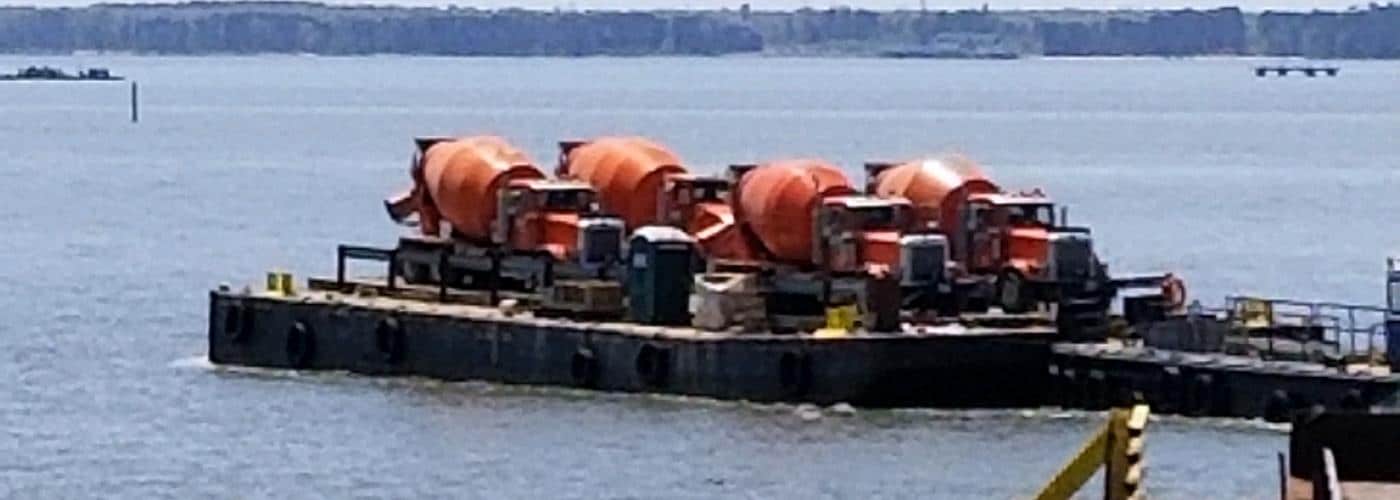 4 concrete trucks on a barge